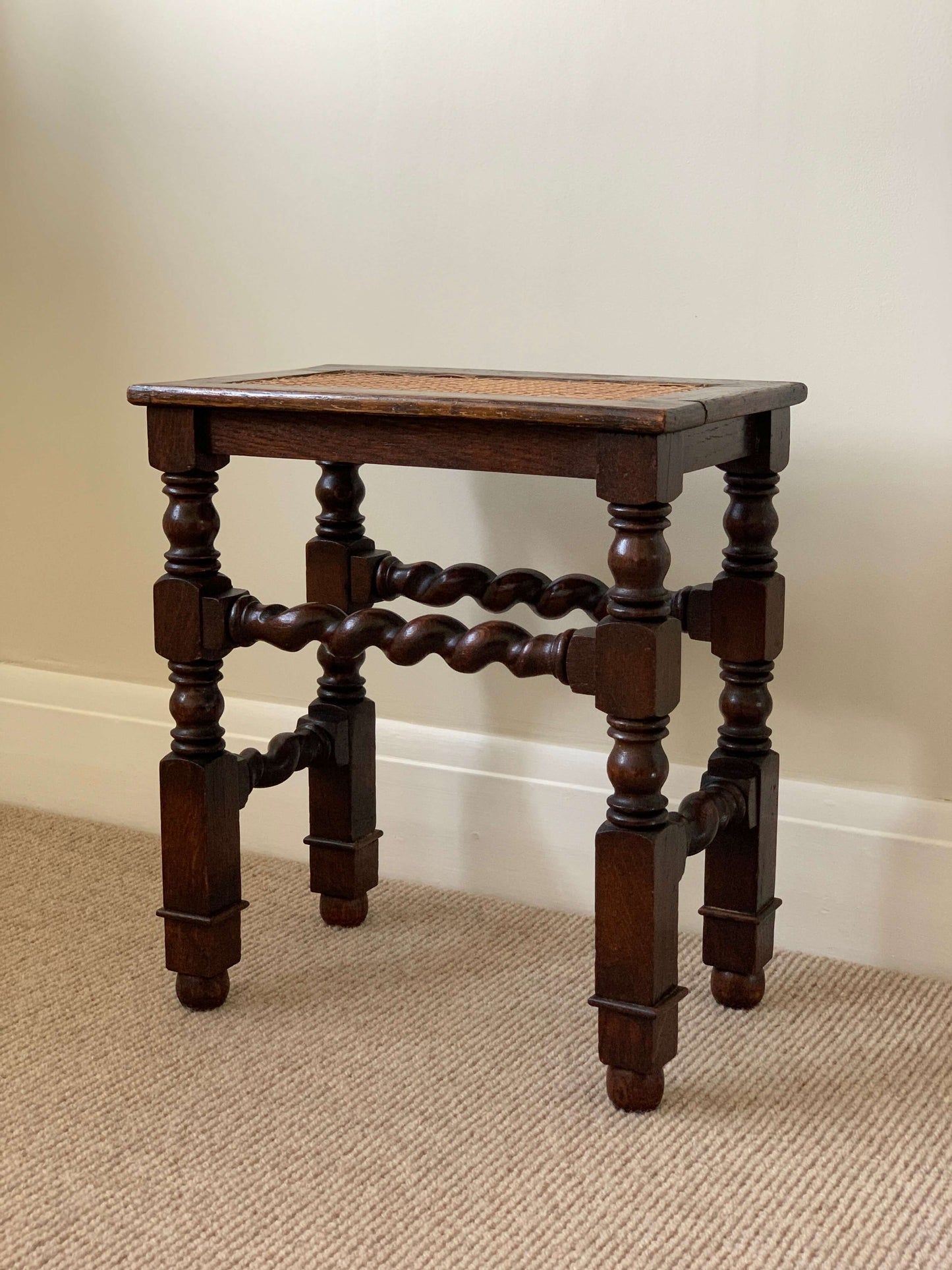 Antique cane stool with twisted detailing